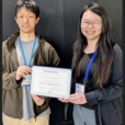 students accepting best paper award