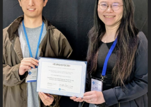 students accepting best paper award