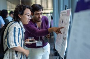 students looking at poster