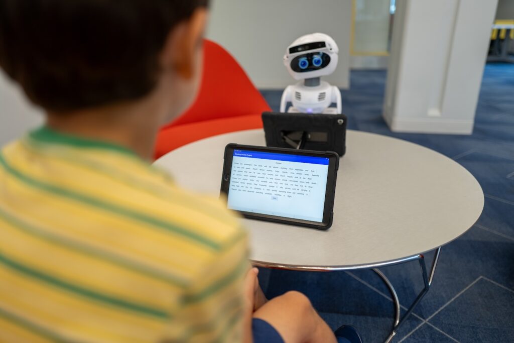 child reading to robot